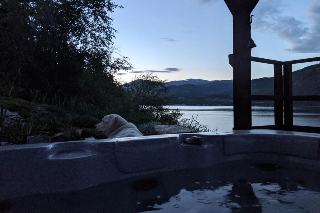 Home Steaming cliffside hot tub overlooking the lake at sunset.